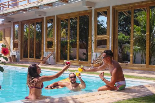 a group of people in a swimming pool drinking at SHANTI SURF CAMP in El Paredón Buena Vista