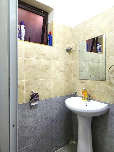a bathroom with a sink and a mirror at MWIGA Bnb in Ruaka