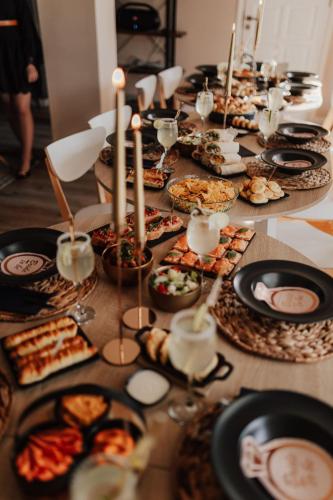 a long table filled with plates of food and candles at FARIE in Faryny
