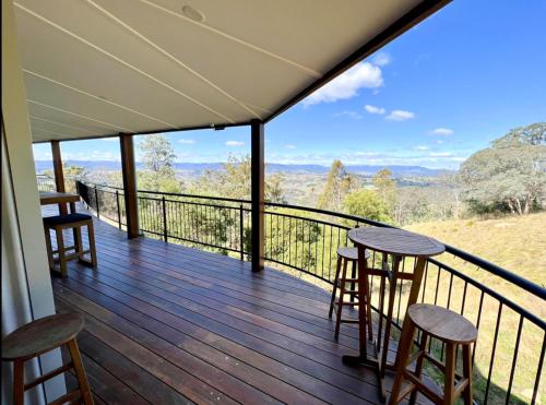 a balcony with stools and a view of the mountains at The View @ Ulandi in Lowther