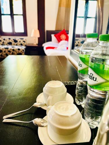 a table with two bottles of water on top of it at Vieng Savanh II Hotel in Luang Prabang