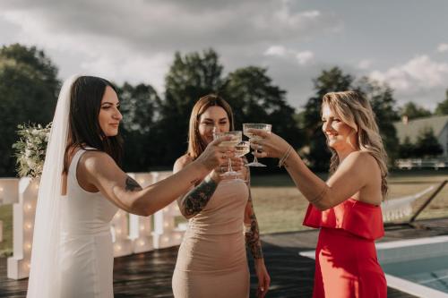 a group of three women holding up wine glasses at FARIE in Faryny