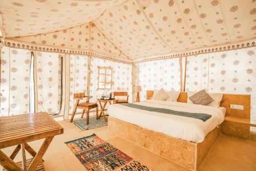 a bedroom with a bed in a room with wallpaper at Tripli Hotels Stay Inn Resort Jaisalmer in Sām