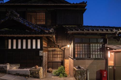 an old house with a lit up facade at night at UFU Kanazawa in Kanazawa