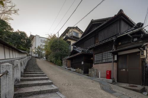 an empty street with some buildings and stairs at UFU Kanazawa in Kanazawa
