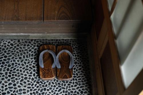 a pair of shoes sitting on a black and white floor at UFU Kanazawa in Kanazawa