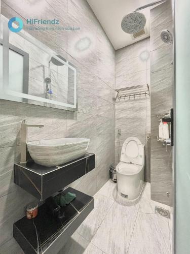 a bathroom with a tub and a sink and a toilet at Moon Apartment in Ho Chi Minh City