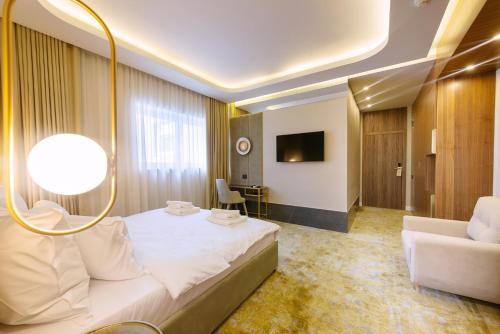 a hotel room with a bed and a couch at Yasu Luxury Rooms in Bucharest