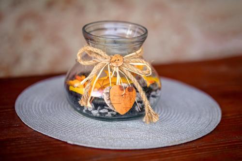 a glass jar filled with fruit and rocks on a plate at Glamping Pod Gwiazdami in Pietrusza Wola
