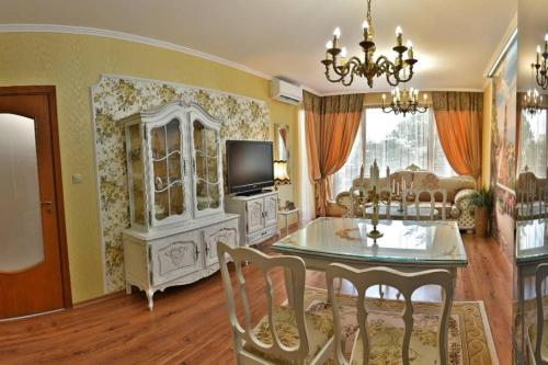 a living room with a dining table and a tv at Luxury apartment Amalfi 300 m from the beach in Varna City