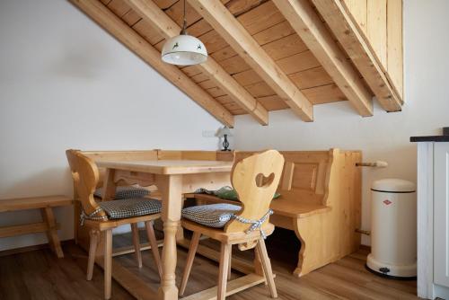 a kitchen with a wooden table and chairs at Alpenhaus Montafon by Pferd auf Wolke in Gargellen