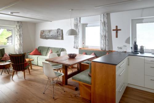 a kitchen and living room with a table and chairs at Alpenhaus Montafon by Pferd auf Wolke in Gargellen