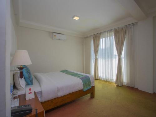 a hotel room with a bed and a window at Hotel Bodhiz TUSAL in Kathmandu