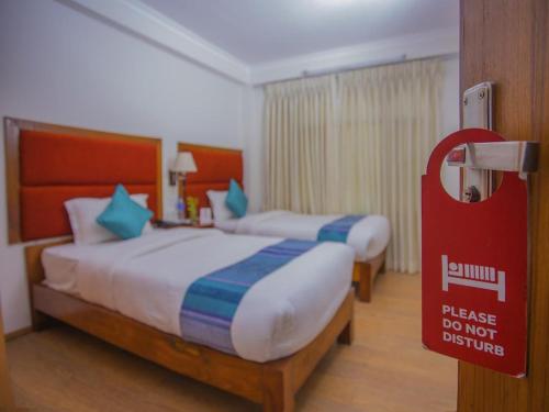 Łóżko lub łóżka w pokoju w obiekcie Hotel Bodhiz TUSAL