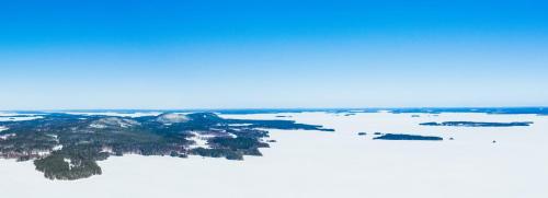 an aerial view of an island in the snow at Break Sokos Hotel Koli Kylä in Kolinkylä
