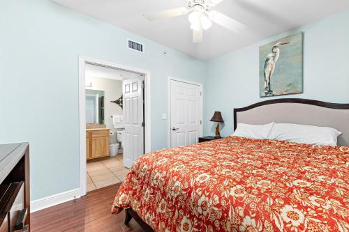 a bedroom with a bed and a bathroom at Crystal Tower 404 in Gulf Shores