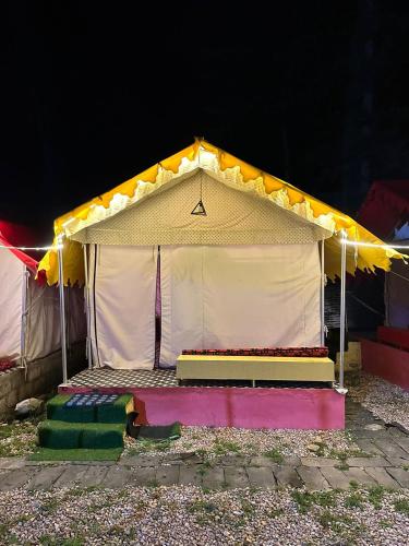 a circus tent is lit up at night at Crown Bliss - Riverside Luxury Paradise in Kasol