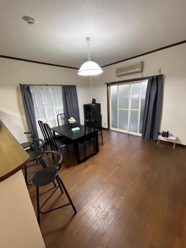 an empty living room with a table and chairs at 高島市一棟貸切 貸別荘グループファミリーok 大人数でご利用だとお得連泊がお得 in Takashima