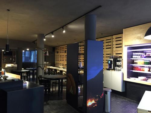 a restaurant with a fireplace in the middle of a room at BASE CAMP alpine apartments in Breuil-Cervinia