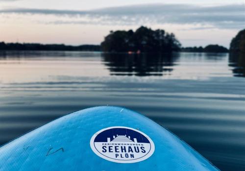a view of the front of a blue kayak on a lake at Seehaus Plön in Plön