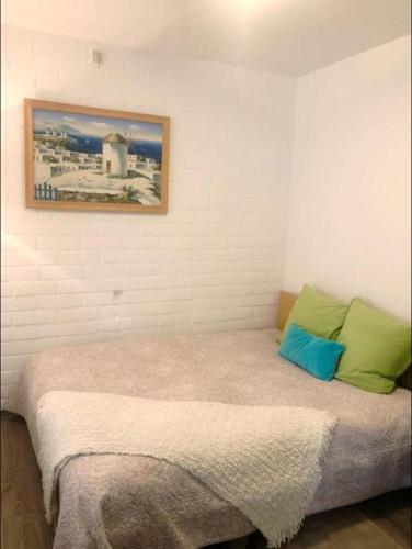 a bed in a room with a picture on the wall at Residence Lilac in Brussels