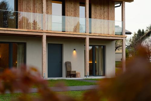 a house with a chair sitting outside of it at Keuschengut in Oberaichwald