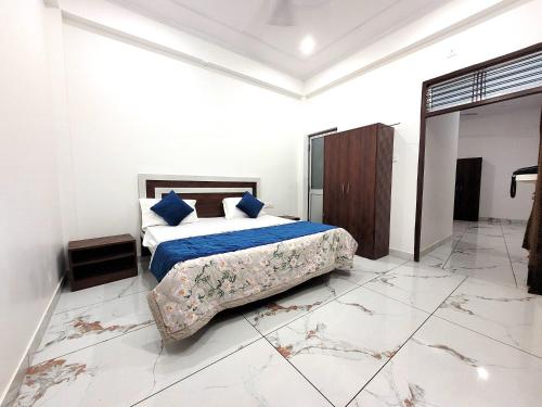 um quarto com uma cama com lençóis azuis e almofadas azuis em Hotel Ramghat inn -River View Chitrakoot em Sītāpur Mūāfi