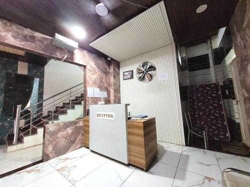 a room with a refrigerator in a room with stairs at Hotel Ramghat inn -River View Chitrakoot in Sītāpur Mūāfi