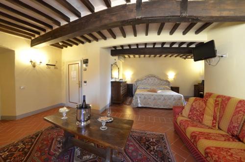 a living room with a bed and a couch at Hotel San Michele in Cortona