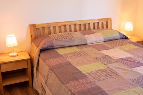 a bedroom with a bed and two lamps on tables at Ollu e Stentu in Dolianova