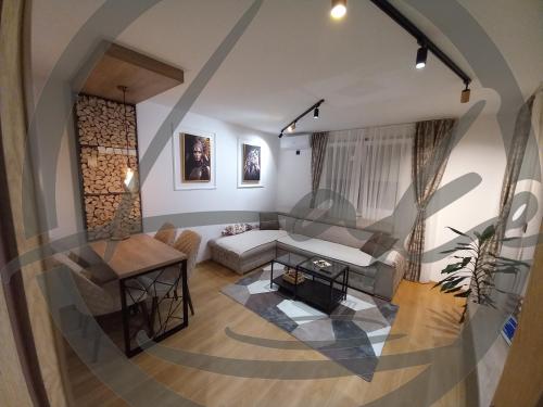 a living room with a couch and a table at Apartman -Cozy Lake- Sarajevo in Lukavica