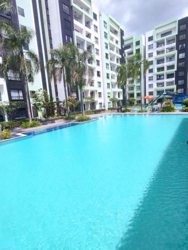 a large swimming pool in front of some buildings at Ipoh Manhattan Water Park Pool View Cozy Homestay in Ipoh