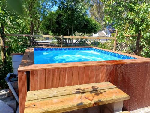 a swimming pool with a bench next to it at Orchard Cottage in McGregor