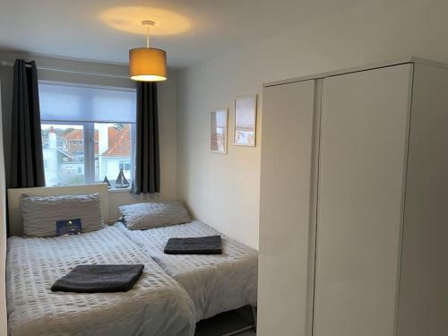 a bedroom with two beds with towels on them at Horizon View in South Hayling