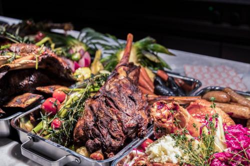 a tray of food with meat and vegetables on a table at InterContinental Haikou Seaview by IHG in Haikou