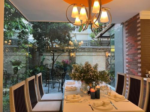 a table in a restaurant with a table and chairs at Luxury Garden Villa with premium spa 4 bedrooms Ciputra in Hanoi