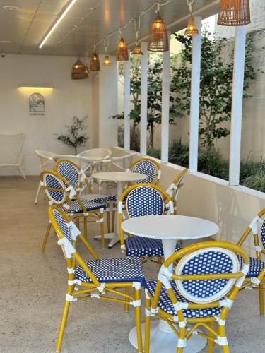 a row of tables and chairs in a restaurant at Paul Mare Pool Villa in Busan
