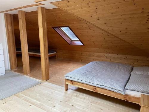 Habitación en el ático con cama y ventana en Centrum FnO en Frýdek-Místek