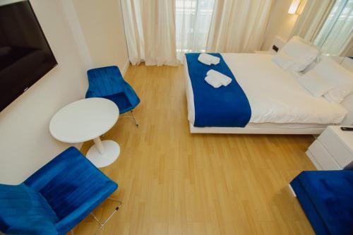 En eller flere senge i et værelse på Orbi City Central Aparthotel