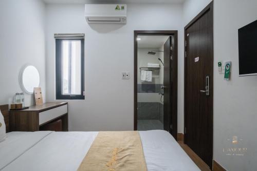 a bedroom with a bed and a bathroom with a shower at Lamour homestay in Thôn Kim Long (1)