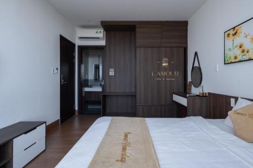 a bedroom with a large white bed and a desk at Lamour homestay in Thôn Kim Long (1)