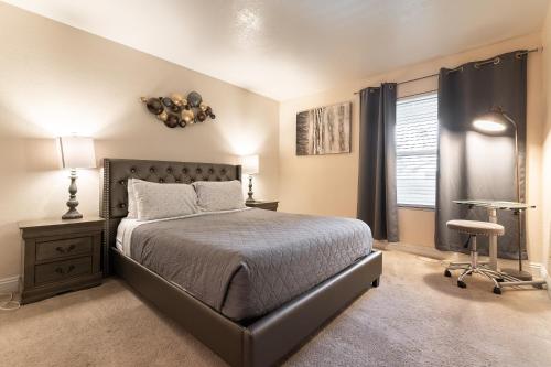 a bedroom with a bed and a desk and a window at Stylish, Cozy 2BR,2BA Condo near Rio, Vegas Luxury in Las Vegas