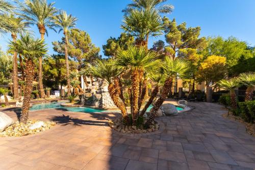 a resort with palm trees and a swimming pool at Rio-Adjacent 2BR Pool, Gym, Free Parking in Las Vegas