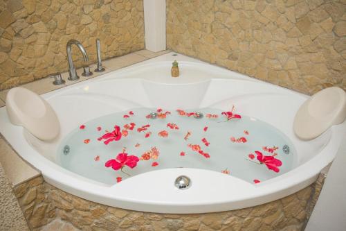 a bath tub with red flowers in it at 7Stones Boracay in Boracay
