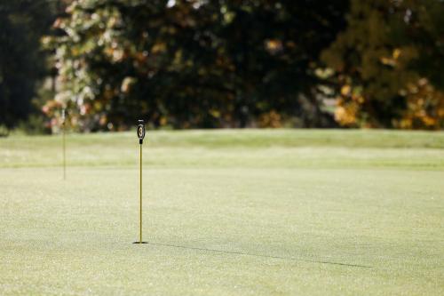 a golf course with two putts on a green at Mercure Luxembourg Kikuoka Golf & Spa in Canach