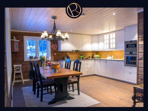 a kitchen with a wooden table and a dining room at Hemsen in Grøndalen