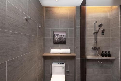 a bathroom with a toilet and a shower at Atour Hotel Kunming Changshui International Airport in Kunming