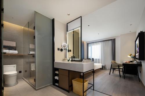 a bathroom with a sink and a mirror at Atour Hotel Tianjin Zhongbei Haitai Industrial Park in Tianjin