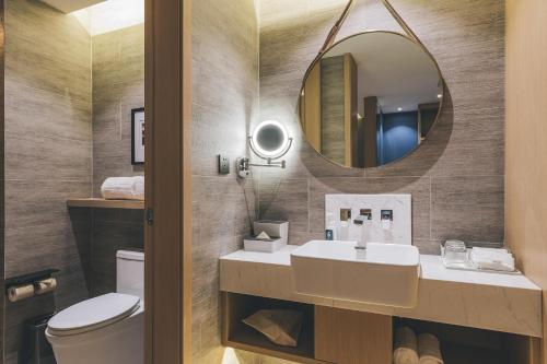 a bathroom with a sink and a mirror at Atour Hotel Lanzhou Dongfanghong Plaza in Lanzhou