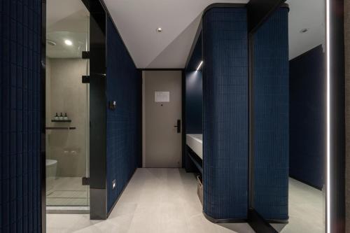 a bathroom with blue tiled walls and a toilet at Atour Light Hotel Jinan Harmony Square Provincial Hospital in Jinan
